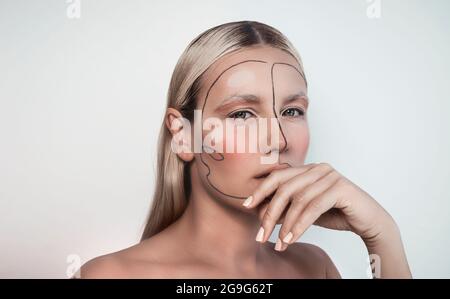 Closeup Portrait of a Girl with Paint on her Face. Modern Photo Shoot. Stylish Look. Gorgeous Beautiful Model Isolated on White Background. Stock Photo