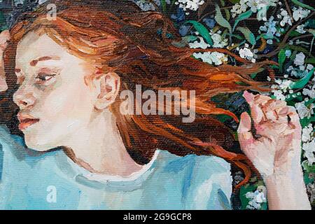 Red-haired beauty, a young girl dreams on the field. Stock Photo