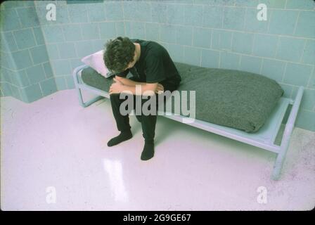 Austin Texas USA, 1989: Anglo teen model poses in a cell at the Gardner-Betts Juvenile Justice Center. ©Bob Daemmrich Stock Photo