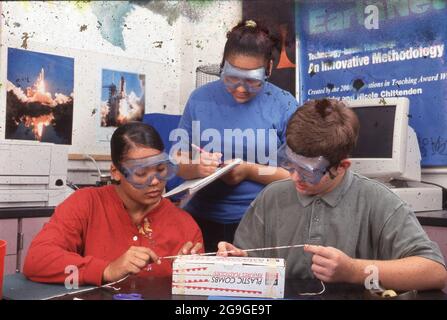 High School students measuring an object with a string in high school science class, Travis HS, Austin, Texas.   MR M673-32P Stock Photo