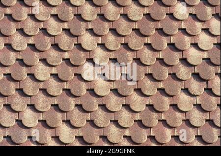 background of scalloped red clay roofing tiles Stock Photo