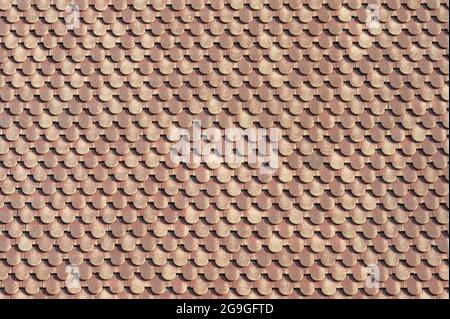 background of scalloped red clay roofing tiles Stock Photo