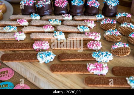 Colorful candies and cookies with baby and newborn symbol pink and blue for Gender reveal. Boy or girl, party and food concept Stock Photo