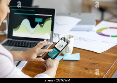 Young woman, manager working at office. Using laptop, modern gadgets. Remote working. Workplace at comapny, home with PC, devices. Stock Photo