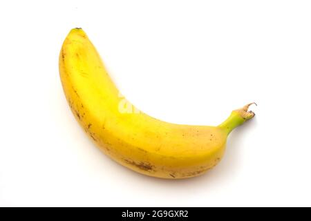 Banana with black spots isolated on white background. Overripe banana Stock Photo