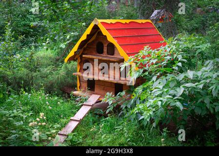 a wooden house for homeless cats stands in the park among the trees Stock Photo