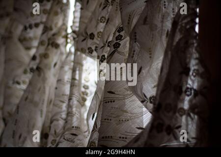 Curtains on the window. Fabric curtains. Lightweight fabric protects from glare. Stock Photo