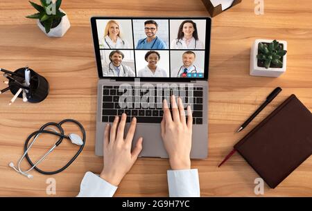 Top View Of Female Doctor Making Group Video Call With Diverse Medical Professionals, Communicating With Distance Colleagues Online During Virtual Web Stock Photo