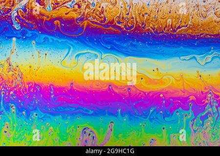 Fluid soap bubble psychedelic colorful abstract art. Surreal patterns with rainbows and waves of color in motion. Stock Photo
