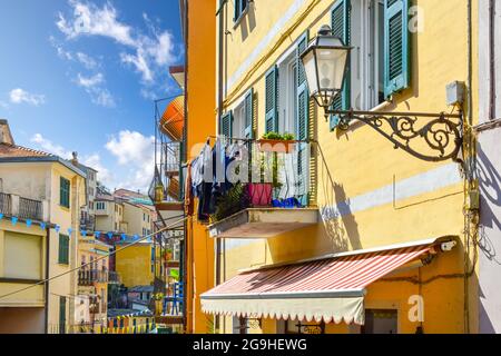 A balcony hung with laundry on the side of a colorful residential apartment house in the village of Manarola, Italy, one of the 5 Cinque Terre village Stock Photo