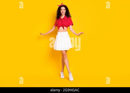 Full size photo of optimistic nice brunette lady stand wear shirt isolated on yellow color background Stock Photo