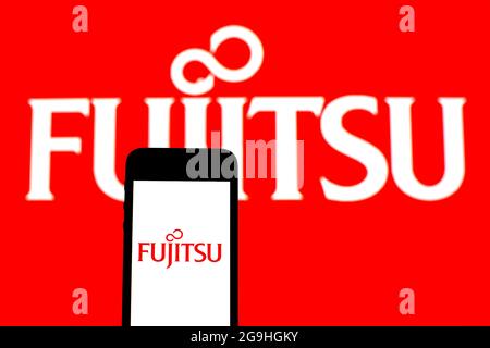 In this photo illustration a Fujitsu Limited logo seen displayed on a smartphone with a Fujitsu Limited logo in the background. (Photo by Thiago Prudencio / SOPA Images/Sipa USA) Stock Photo