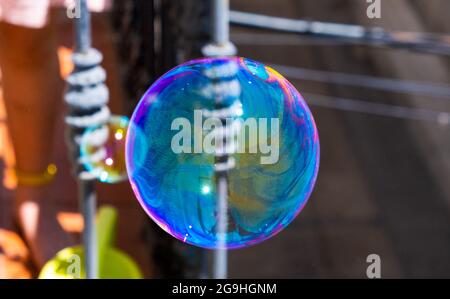 Soap bubbles flying into the sky from a balcony. Game, freedom, concept Stock Photo