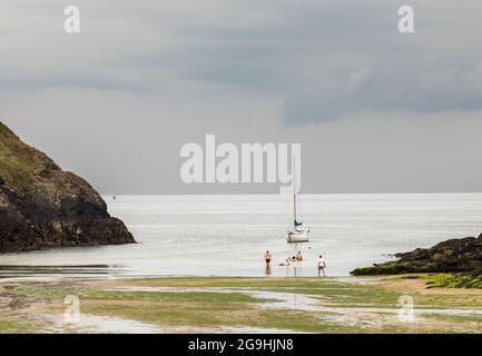 Roberts Cove, Cork, Ireland. 26th July, 2021. With a change in the weather some young people go for a swim before the onset of rain at Roberts Cove, Co. Cork, Ireland. - Picture; David Creedon / Alamy Live News Stock Photo