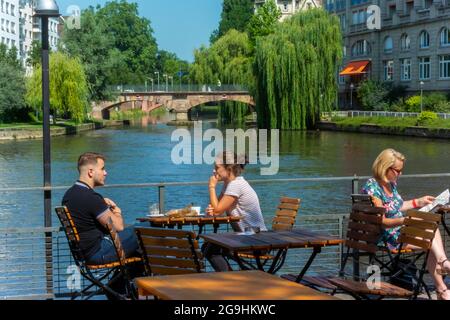 Strasbourg, France, Young People Sharing Meals on Rhone River Bank, Quai Bateliers, Scenics, French 'Cafe Bateliers' Terrace Tables, Exterior Outside Stock Photo