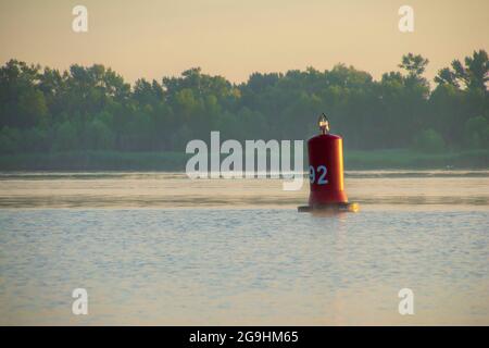 A red buoy on the Dnieper river in Kiev, Ukraine, for the safety and security of the boats travelling on the water. Stock Photo