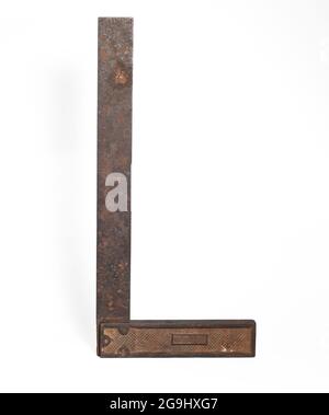 vintage machinist layout square tool over white. an old metal corner ruler isolated. Stock Photo