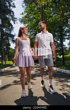 Loving couple walking along the road in the countryside Stock Photo