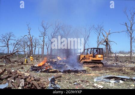 Brenham Texas USA, April 71992:  Bulldozer removes rubble after a natural gas pipeline explosion leveled a rural area outside of Brenham, killing one person and several cattle, and injuring a score of people. ©Bob Daemmrich Stock Photo