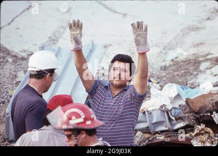 Brownsville Texas USA, July 8,1988: Volunteer rescuers comb the rubble of the Amigo store in downtown Brownsville. Heavy rains caused the building to collapse, killing 14 people. Engineers determined faulty construction on a third-story addition as the cause of the collapse. ©Bob Daemmrich Stock Photo