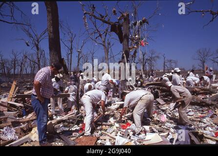 Brenham Texas USA, April 71992:  Rescuers pick through rubble after a natural gas pipeline explosion leveled a rural area outside of Brenham, killing one person and several cattle, and injuring a score of people. ©Bob Daemmrich Stock Photo