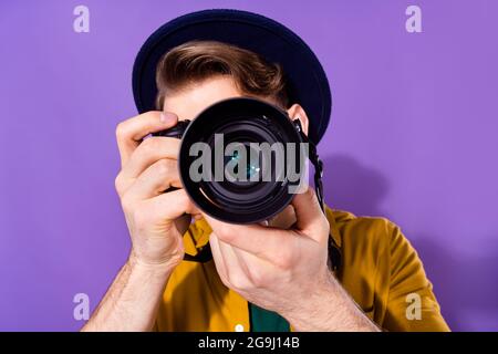 Portrait of nice skilled guy holding using cam shooting you travel tour isolated over bright violet purple color background Stock Photo