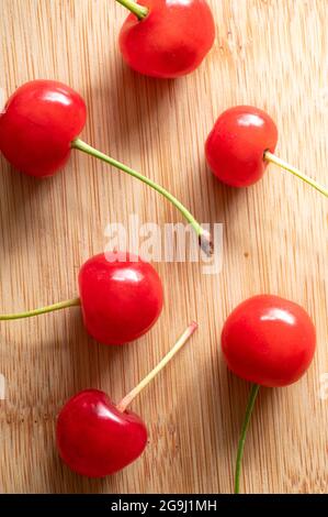 Top View of Red Cherries on a Wood Table Stock Photo