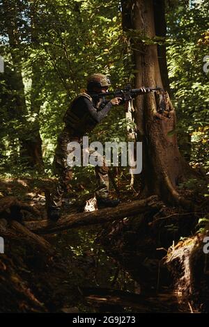 Female person in dangerous military conditions of war Stock Photo
