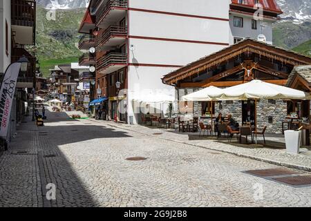 View of Breuil Cervinia, a popular resort town in Aosta Valley under the Matterhorn. Breuil-Cervinia, Italy, June 2021 Stock Photo