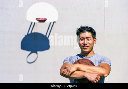 Portrait of a man on a basketball court outside. Stock Photo