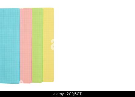 Colored checkered sheets isolated on a white background. Multicolored notepad sheets. Mockup or template. Copy space, top view, flat lay. Stock Photo