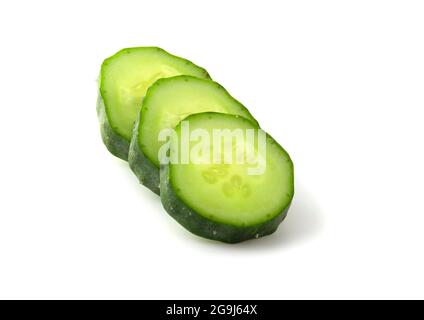Fresh slices of cucumber sliced into ice cubes isolated on white background Stock Photo