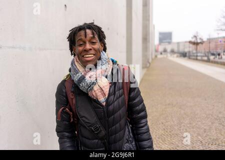 Germany, Berlin, Portrait of smiling man in city Stock Photo