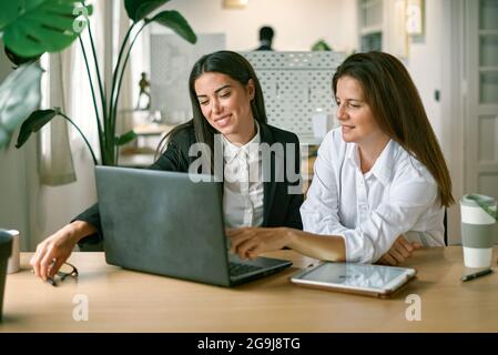 Female employees working on project together Stock Photo
