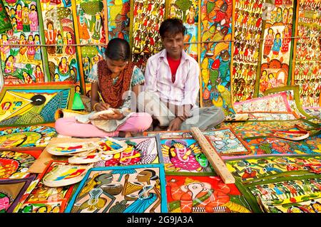 KOLKATA, WEST BENGAL , INDIA - DECEMBER 14TH 2013 : Unidentified couple painting Artworks of handicraft, at Handicraft Fair in Kolkata. Stock Photo