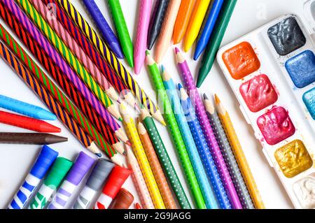 Subjects for drawing. Colored pencils, crayons, markers and paints on white background Stock Photo