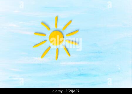 Sun on blue sku. Made from plasticine Stock Photo