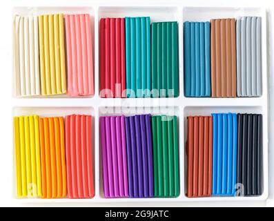 Open box with a new set of multi-colored plasticine. Multicolor plasticine blocks background Stock Photo