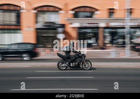 Ukraine, Kyiv - 16 July 2021: Black Motorcyle moving on the street. Editorial Stock Photo