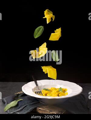 Creative concept with falling food on black backdrop Stock Photo