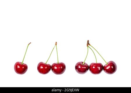One, two and three Ripe red sweet cherry isolated on white background. Macro photo close up. Stock Photo