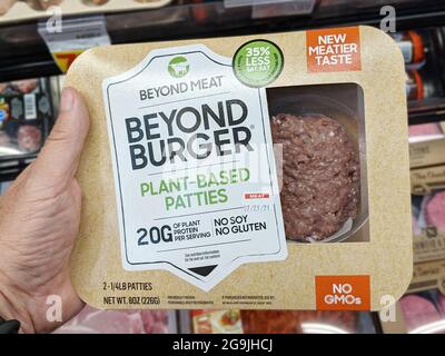 Lake Elsinore, CA, USA - July 24, 2021: Shoppers hand holding a package of Beyong Meat brand plant based burger patties Stock Photo