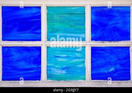A blue and green stained glass window is pictured on Dauphin Street, July 23, 2021, in Mobile, Alabama. Stock Photo