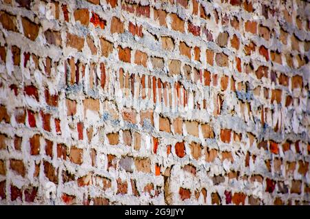 A historic brick wall shows messy mortar, also called weeping mortar, on July 23, 2021, in Mobile, Alabama. Stock Photo
