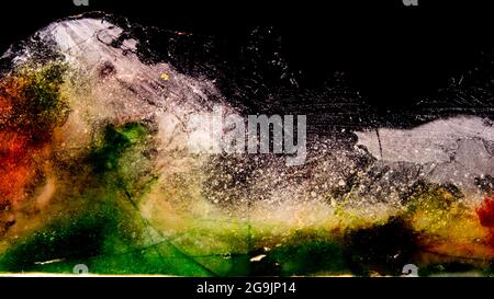 Multicolored ice plate melting, colors overflowing Stock Photo