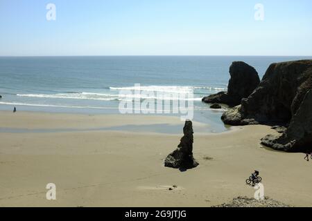 People enjoying the beach as seen from Face Rock State Scenic Viewpoint in Bandon, Oregon. Stock Photo