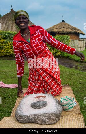 Woman preparing local bread at a ceremony of former poachers, in the Virunga National Park, Rwanda, Africa Stock Photo