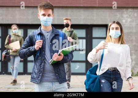 Two teenage students in protective masks Stock Photo