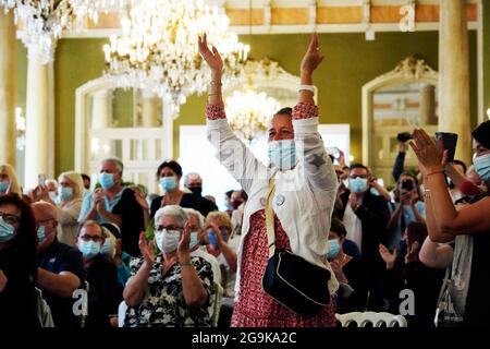 (210727) -- PARIS, July 27, 2021 (Xinhua) -- People applaud at the Napoleon III hall of Palais des Congres-Opera in Vichy, France when they see the online session of the World Heritage Committee decide to add 'The Great Spa Towns of Europe' to UNESCO World Heritage List, July 24, 2021. TO GO WITH 'Feature: French spa city Vichy revels in UNESCO World Heritage status' (The City of Vichy/Handout via Xinhua) Stock Photo