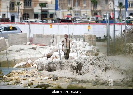 Marsaxlokk, Malta. 26th July, 2021. An officer of the Armed Forces of Malta is seen in Marsaxlokk, Malta, July 26, 2021. The Armed Forces of Malta on Monday evacuated swimmers after the discovery of an unexploded World War II bomb in Marsaxlokk. Credit: Jonathan Borg/Xinhua/Alamy Live News Stock Photo